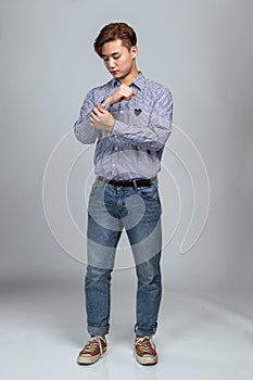 Studio portrait of an East Asian man dressed in clothes