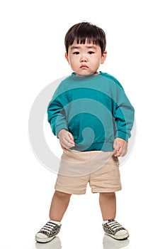 Studio portrait of an East Asian young child with a serious look on a white background