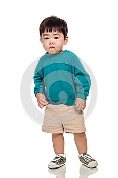 Studio portrait of an East Asian young child with a serious look on a white background