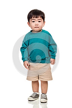 Studio portrait of an East Asian young child with a serious look on a white background