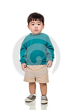 Studio portrait of an East Asian young child with a serious look on a white background