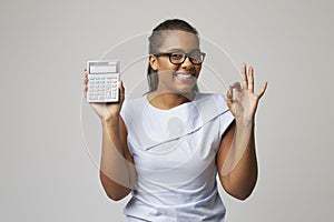 Studio Portrait Of Female Accountant Using Calculator