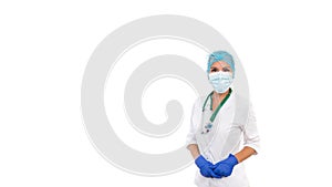 Studio portrait of female doctor on white isolated background. The doctor is wearing a white coat, a medical mask, blue styryl