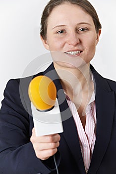 Studio Portrait Of Female Journalist With Microphone