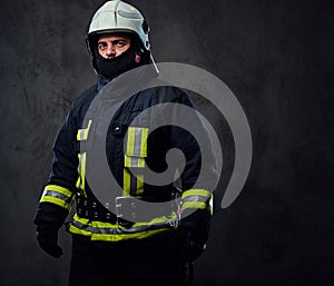 Studio portrait of firefighter dressed in uniform.