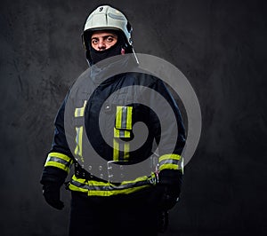 Studio portrait of firefighter dressed in uniform.