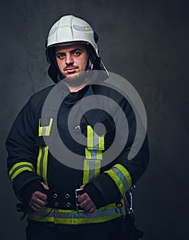 Studio portrait of firefighter dressed in uniform.