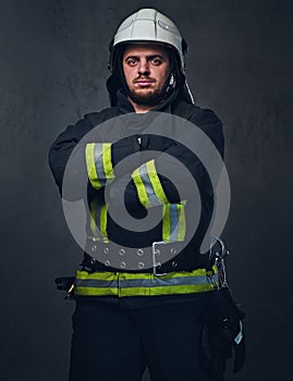 Studio portrait of firefighter dressed in uniform.