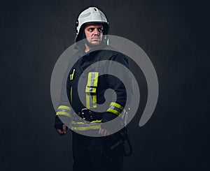 Studio portrait of firefighter dressed in uniform.