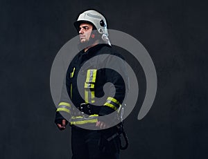 Studio portrait of firefighter dressed in uniform.