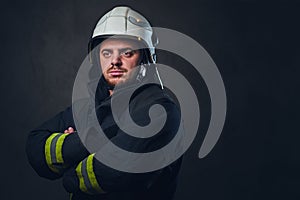 Studio portrait of firefighter dressed in uniform.