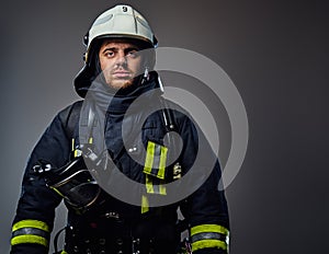 Studio portrait of firefighter dressed in uniform.