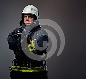 Studio portrait of firefighter dressed in uniform.