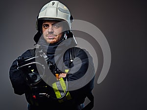 Studio portrait of firefighter dressed in uniform.