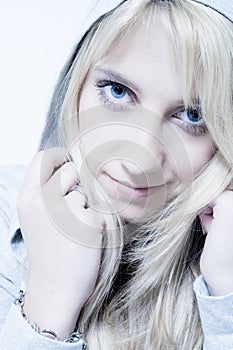 Studio portrait of friendly looking a long blond g