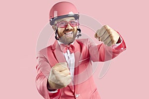 Studio portrait of funny happy man laughing while pretending to drive invisible car