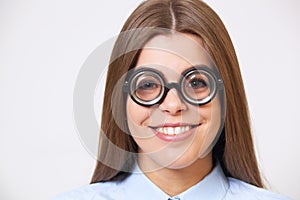 Studio portrait of funny young business woman in nerd glasses