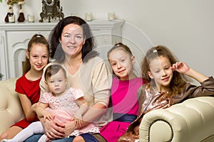 Studio Portrait of Happy Family of Mother and Three Daughters