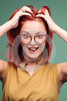 Studio portrait of a happy girl with brown hair.