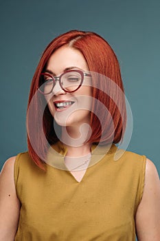 Studio portrait of a happy girl with brown hair.