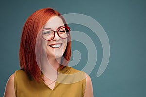 Studio portrait of a happy girl with brown hair.