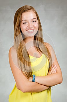 Studio portrait of happy teen girl smiling