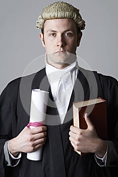 Studio Portrait Of Lawyer Holding Brief And Book