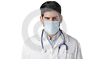 Studio portrait of male doctor wearing surgical mask while standing at isolated white background