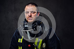 Studio portrait of a male dressed in a firefighter uniform.