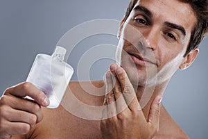 Studio, portrait and man with cologne for skincare, grooming and facial treatment or aftershave. Model, face and happy