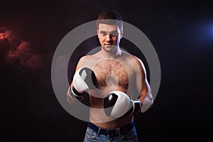 Studio portrait of a muscular boxer in professional gloves of Eu