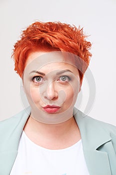 Studio portrait of pretty redhead woman