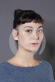 Studio portrait of a serious 20s woman