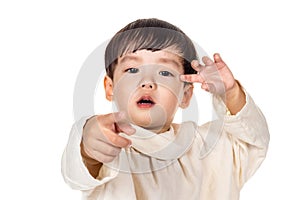 Studio portrait of sincere but mischievous asian boy child