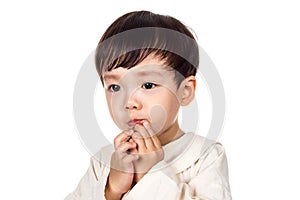 Studio portrait of sincere but mischievous asian boy child