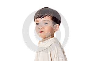 Studio portrait of sincere but mischievous asian boy child