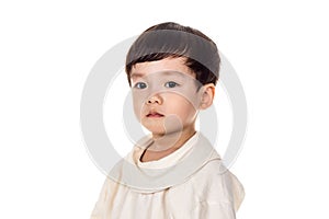 Studio portrait of sincere but mischievous asian boy child