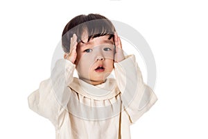 Studio portrait of sincere but mischievous asian boy child