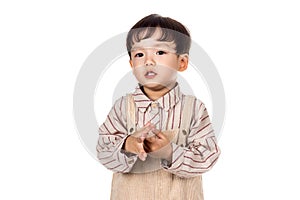 Studio portrait of sincere but mischievous asian boy child