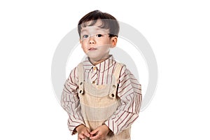 Studio portrait of sincere but mischievous asian boy child