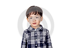 Studio portrait of sincere but mischievous asian boy child