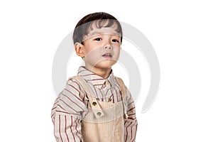 Studio portrait of sincere but mischievous asian boy child