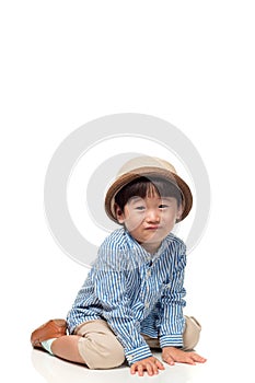 Studio portrait of a sitting and pounded East Asian male child