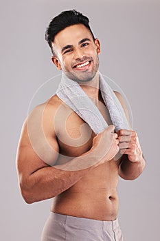 Studio portrait smile, man towel self care against grey wall for cosmetics beauty and healthy skin. Skincare health