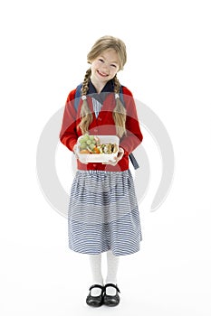 Studio Portrait of Smiling Girl Holding Lunchbox