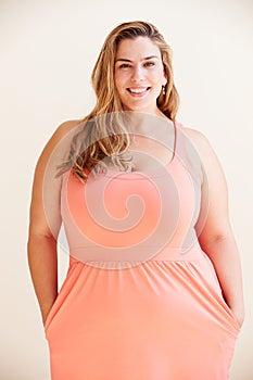 Studio Portrait Of Smiling Overweight Woman