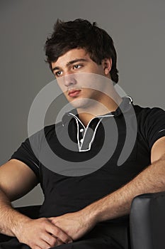 Studio Portrait Of Smiling Teenage Boy