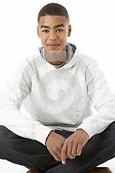 Studio Portrait Of Smiling Teenage Boy