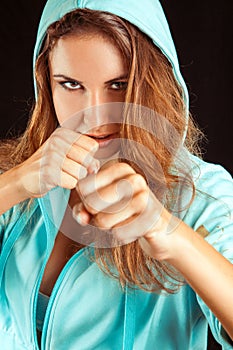 Studio portrait of sports woman on boxing stance