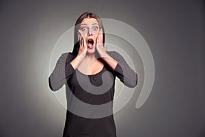 Studio portrait of startled young woman